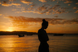 woman at a lake at sunset