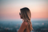 Woman with blonde hair looking at the sunset
