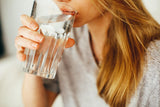 Blonde woman drinking glass of water