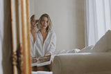 Blonde woman looking in mirror